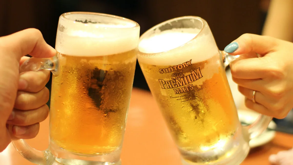 Contact Two glasses of beer touching in a "cheers" gesture